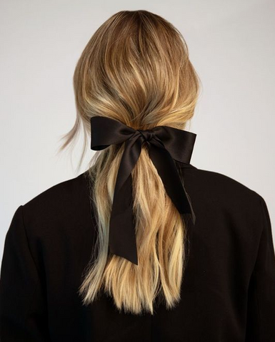 loose, low ponytail hairstyle with ribbon