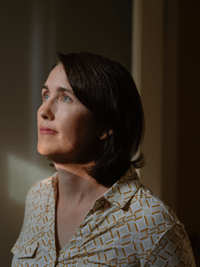 photo of dark-haired woman in 3/4 profile looking up 