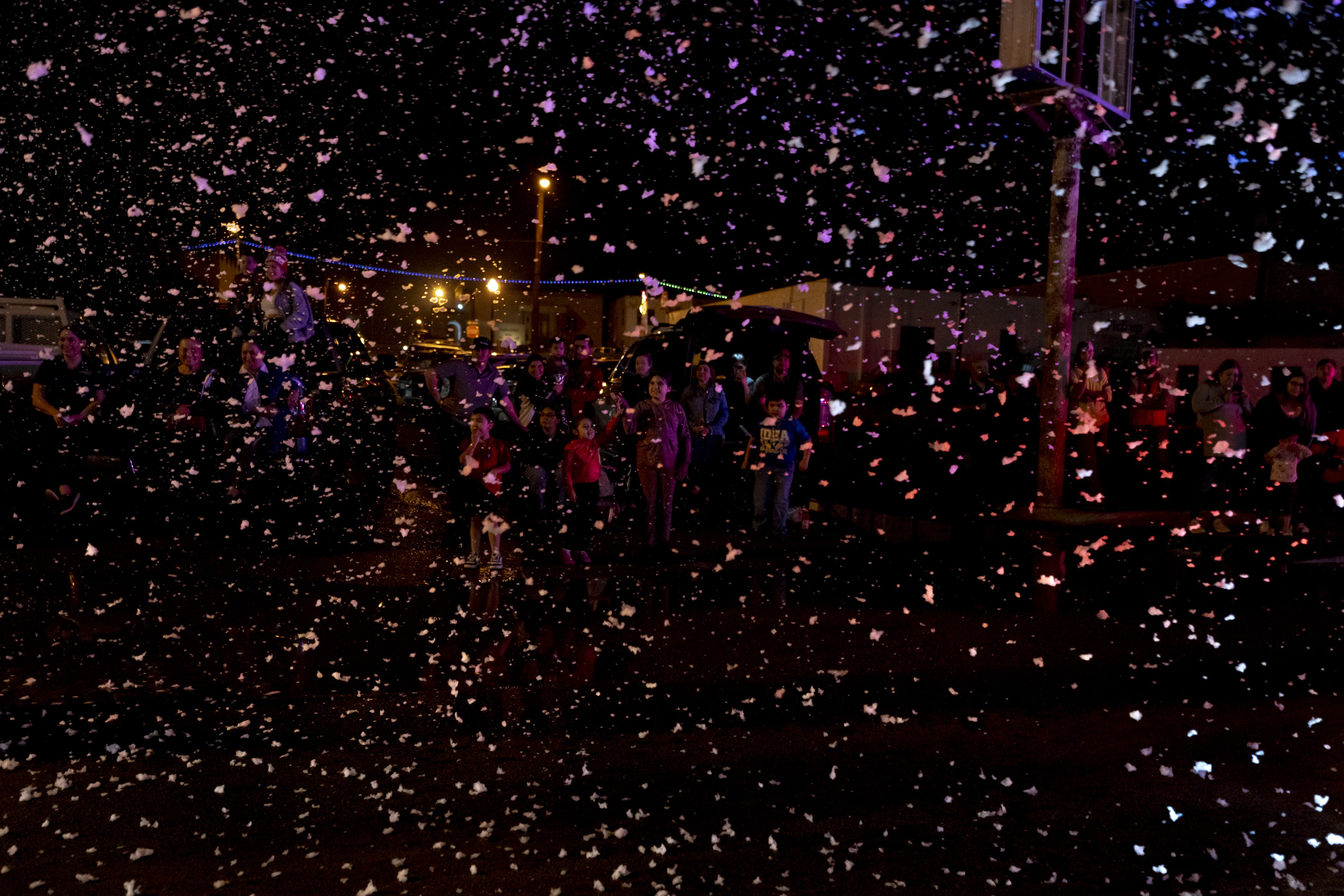 Picture of floats sending foam snow fluttering down during a Christmas parade in Rio Grande City in December 2023.