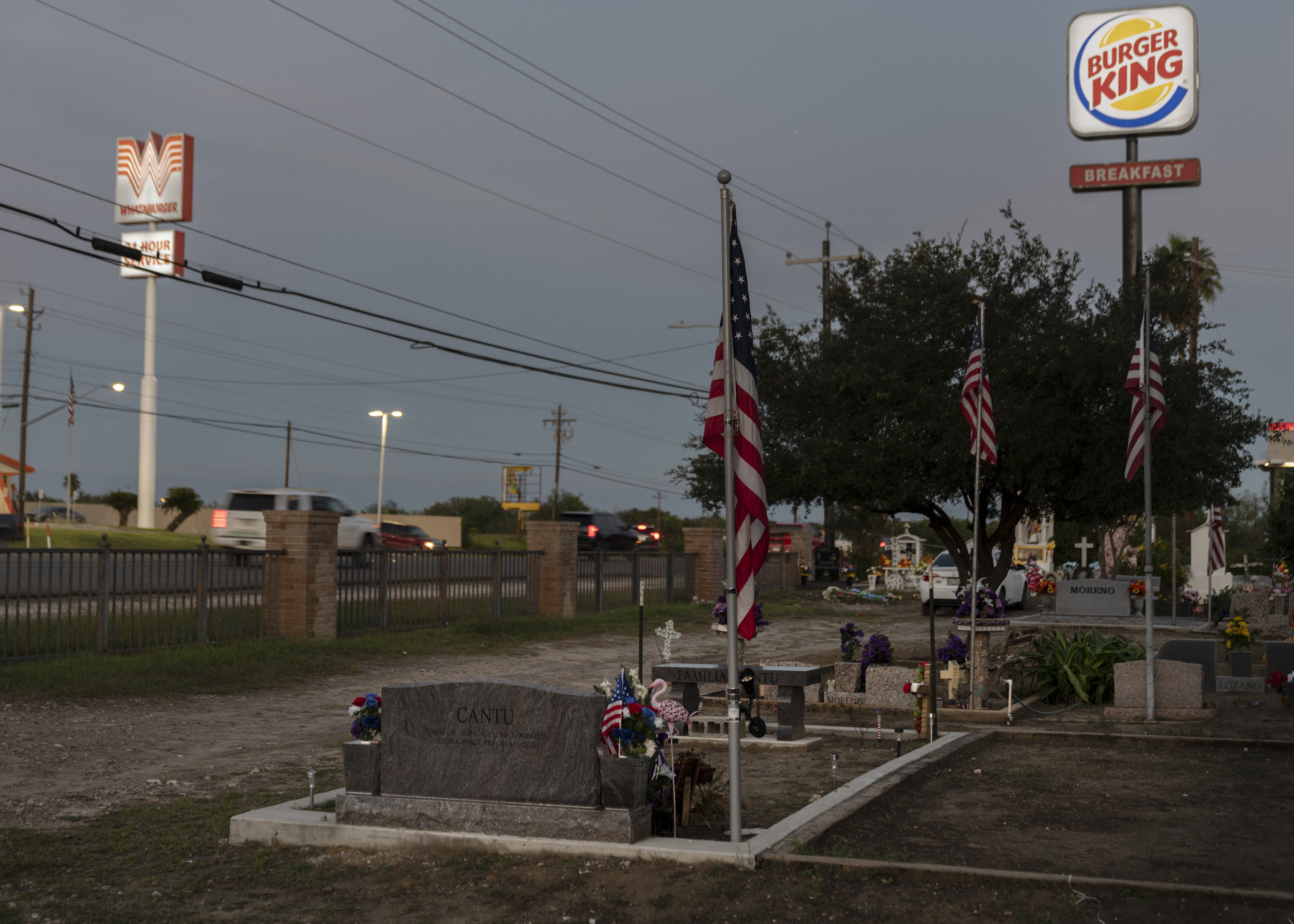 A photograph of Tomas Cantú’s headstone across from a Whataburger in Roma, Texas.